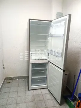 Refrigerator in the kitchen with the door open. - image 7