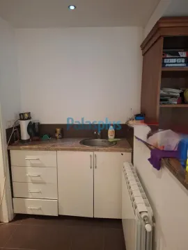 Small kitchen with a sink, cabinetry, and a countertop. - image 6
