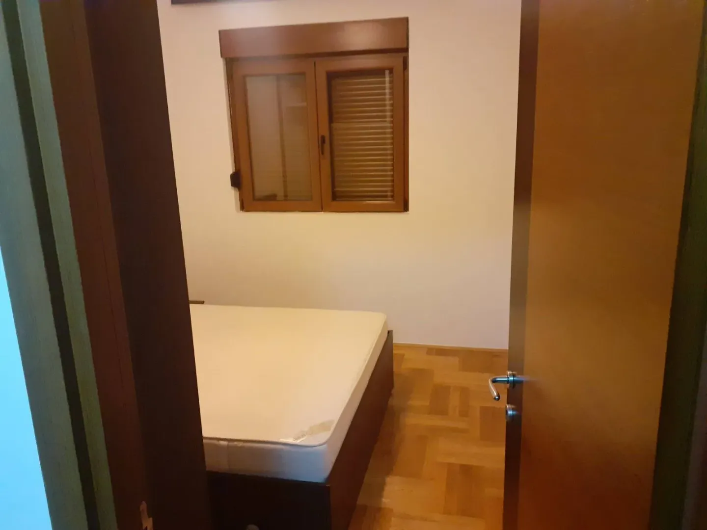 Bedroom with a bed and a window.