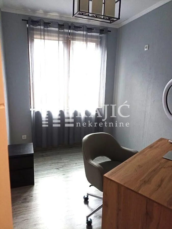 Small room with a desk and an armchair.