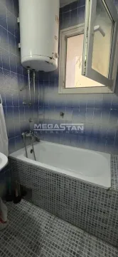 Bathroom with a bathtub and a water heater on the wall. - image 8