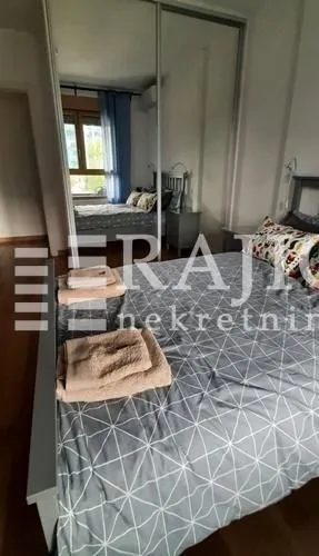 Furnished bedroom with a large wardrobe and a double bed.