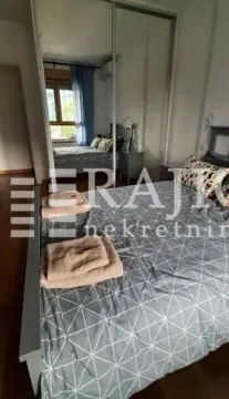 Furnished bedroom with a large wardrobe and a double bed. - image 4