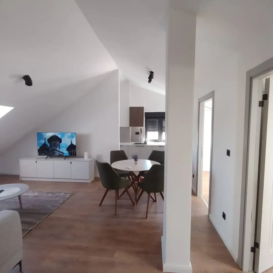 Living room with dining area and kitchen in the background.