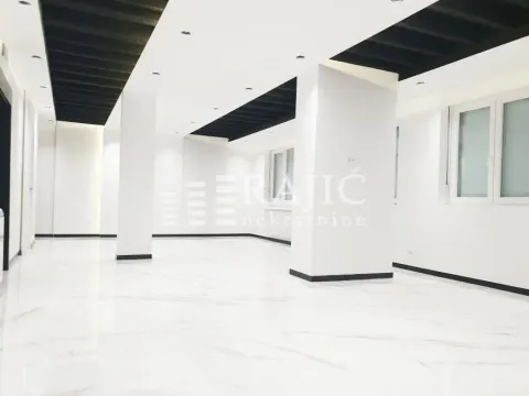 Spacious and bright empty space with white flooring and columns. - image 3