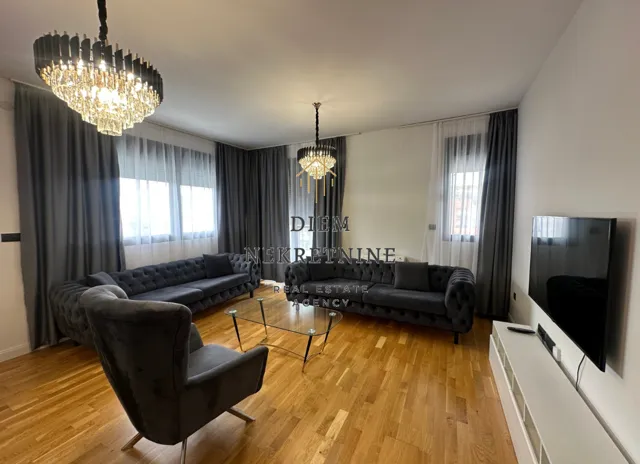Modern and bright living room with a sofa set and TV.