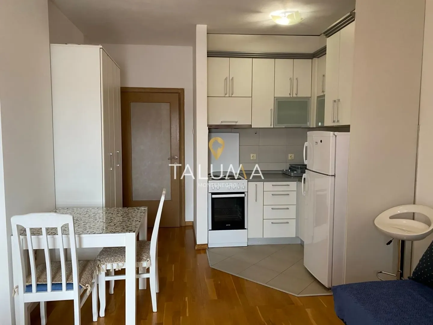 Kitchen equipped with white cabinets and a dining area.