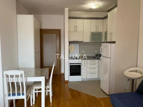 Kitchen equipped with white cabinets and a dining area. - image 2