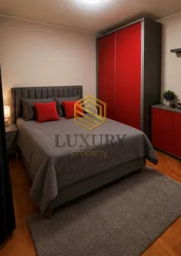 Furnished bedroom with a double bed, wardrobe, and parquet flooring. - image 4