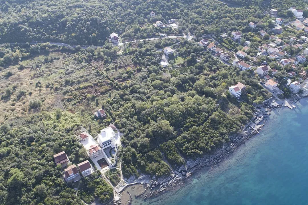Pogled iz vazduha na priobalno naselje i okolnu prirodu.