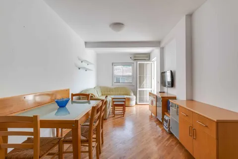 Living room with dining area and wooden furniture. - image 2