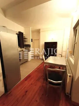 Kitchen with dining area and wooden floor. - image 7