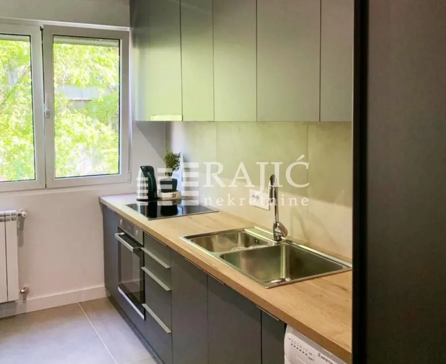 Modern kitchen with wooden countertops and built-in units.