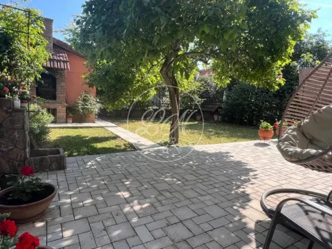Landscaped courtyard with a paved area, lawn, and trees. - image 18