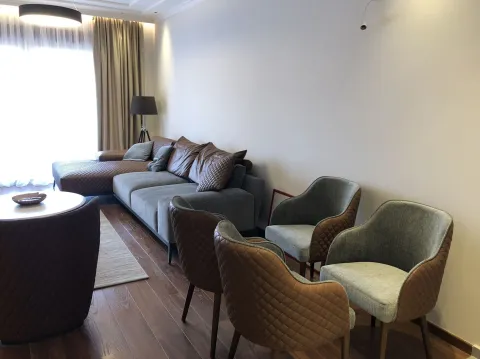 Bright living room featuring a modern sectional sofa and comfortable armchairs. - image 3
