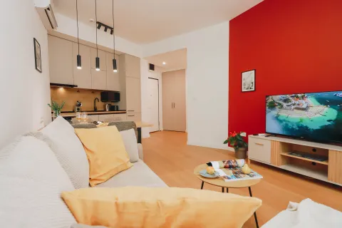 Modern living room with a sofa and dining area in the background. - image 2