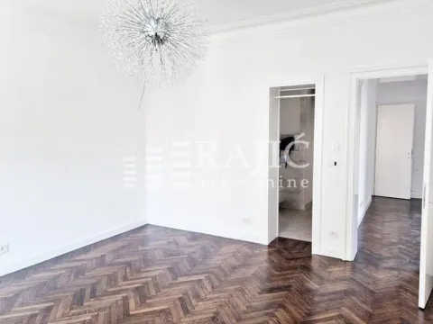 Bright room with parquet flooring and a decorative chandelier. - image 6