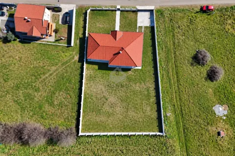 Aerial view of the house with a fenced yard and red tile roof. - image 13