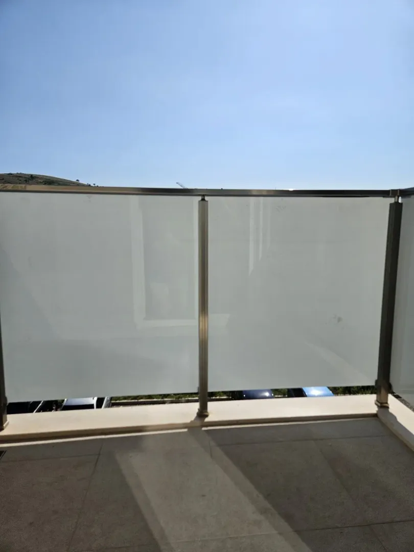 View from a balcony with a modern glass railing.