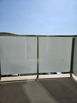 View from a balcony with a modern glass railing. - image 6
