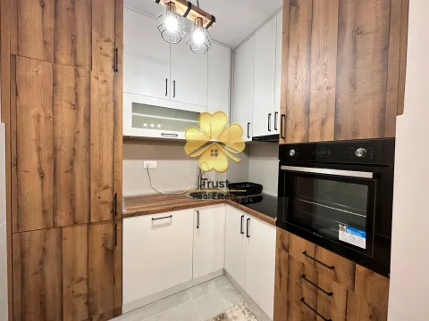 Modern kitchen with white cabinets and wooden details. - image 4