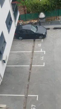 Top-down view of parking spaces and part of the building. - image 5
