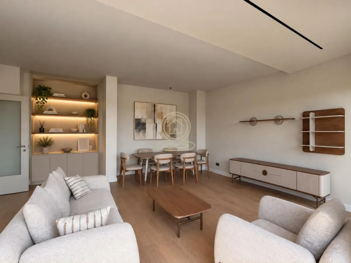 Living room with a sofa set, dining area, and built-in illuminated shelves.