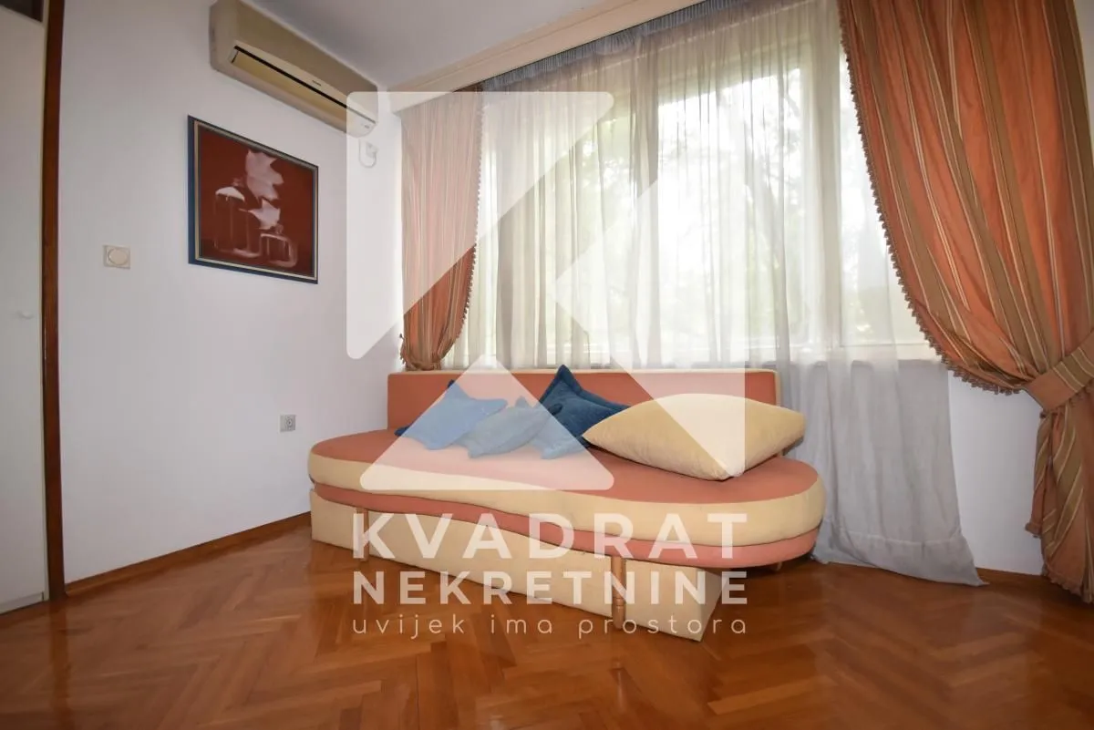 Living room with a sofa and parquet flooring.