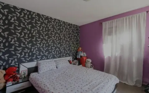 Furnished bedroom with a double bed and decorative wallpaper. - image 5