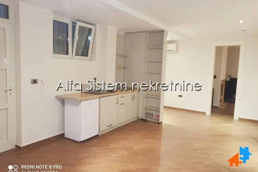 Small kitchen with cabinets and built-in appliances in the apartment.