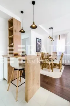 Living room with a dining area and a bar counter. - image 5