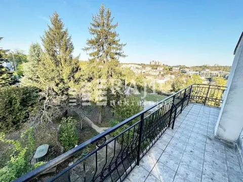 Spacious balcony with metal railing and view of greenery and surroundings. - image 18