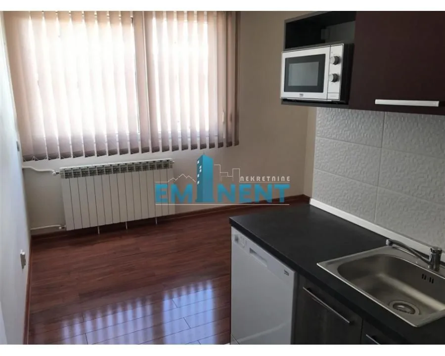 Small kitchen with a sink, countertop and built-in units.