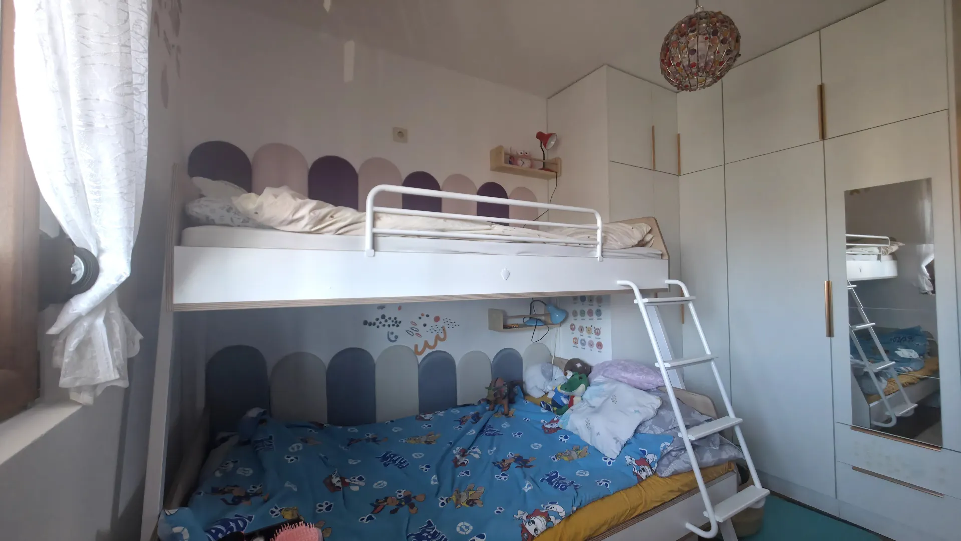 Children's bedroom with a bunk bed and fitted wardrobe.