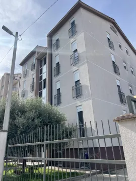 Fasada višespratne stambene zgrade sa metalnom ogradom u prvom planu. - image 18