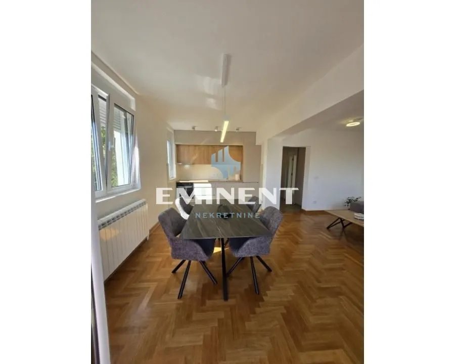 Living room with dining area and kitchen in the background.