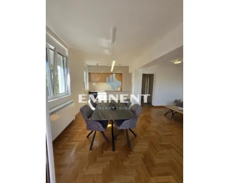 Living room with dining area and kitchen in the background. - image 5