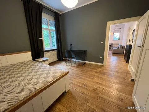 Bedroom with a double bed, desk, and a view of the hallway. - image 7