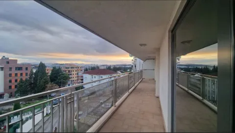 A long balcony with a city view. - image 14