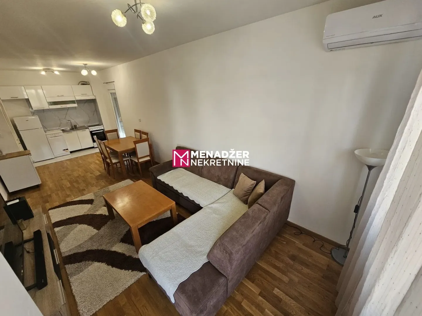 Living room connected with dining area and kitchen.