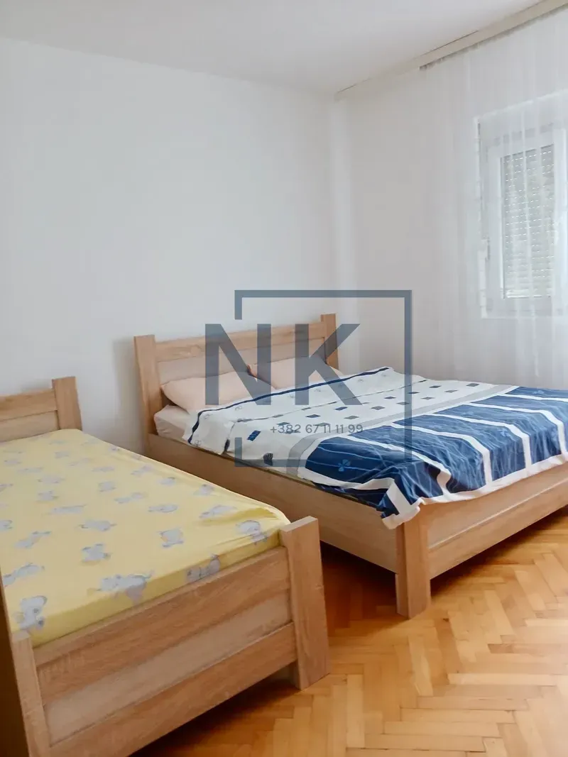 Bedroom with a double bed and an additional single bed.
