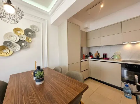 Moderna kuhinja sa trpezarijskim stolom i dekorativnim zidnim detaljima. - image 13