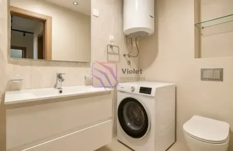 Bathroom equipped with a washbasin, washing machine, water heater, and toilet. - image 15