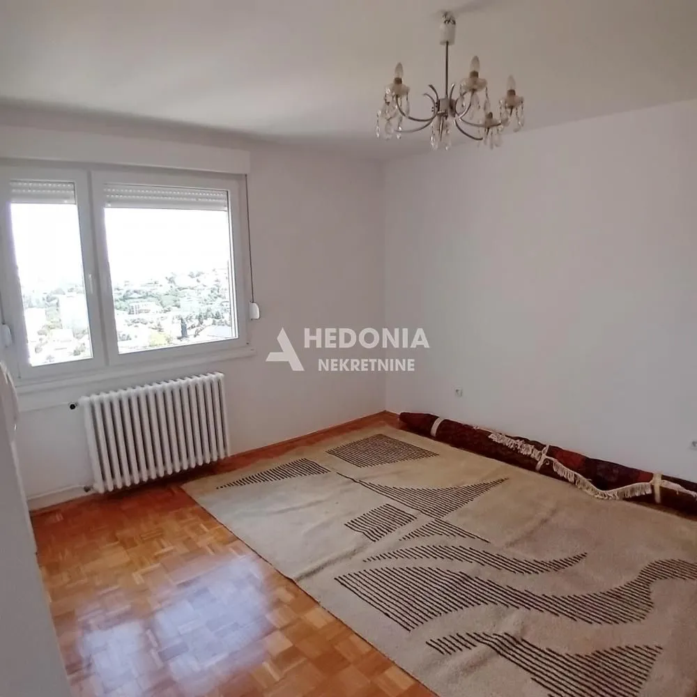 Empty room with parquet flooring, a window, and a chandelier.