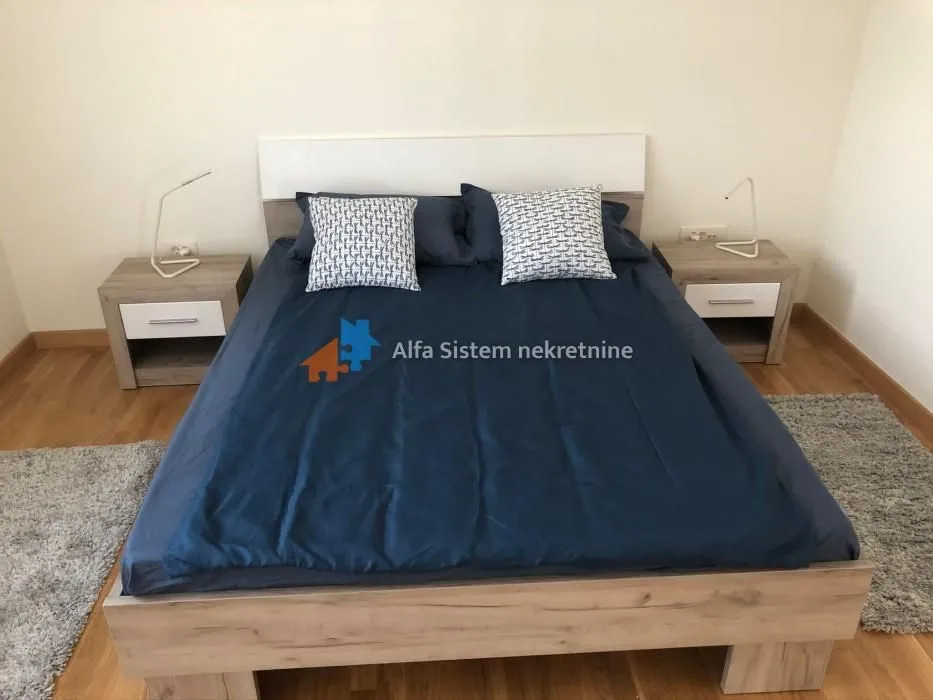 Furnished bedroom with a double bed and nightstands.