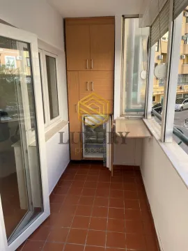 Enclosed balcony with a built-in closet and a small refrigerator. - image 7