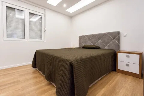 Modern bedroom with a double bed and a nightstand. - image 11