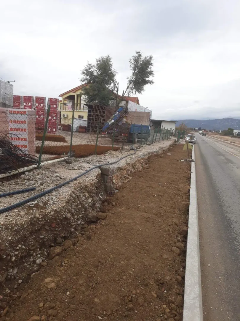 Construction plot next to the road with building materials.