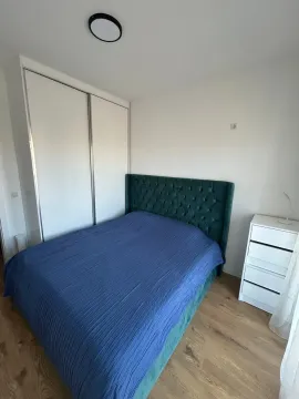 Bedroom with a double bed, wardrobe, and chest of drawers. - image 4