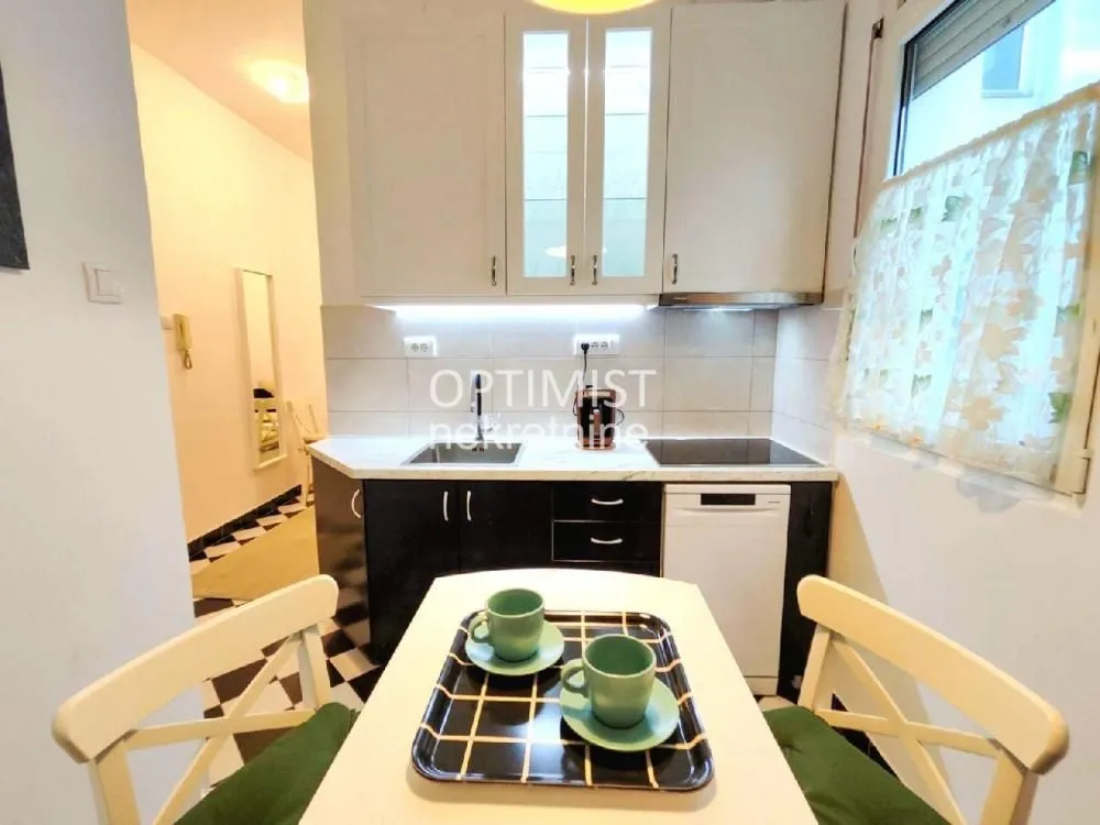 Small equipped kitchen with a dining table and chairs.